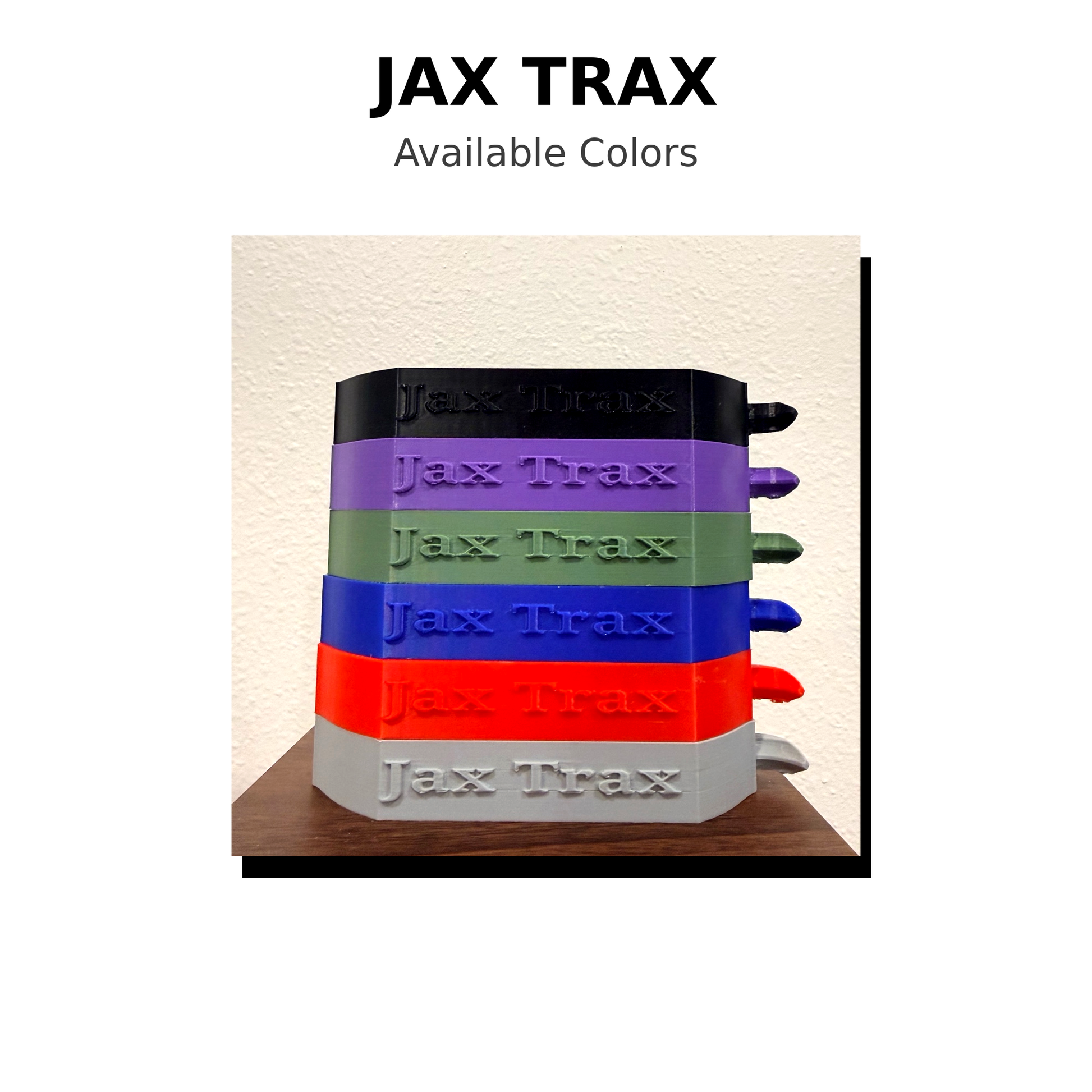 Stack of Jax Trax products in various colors on a wooden surface with 'Jax Trax' branding.